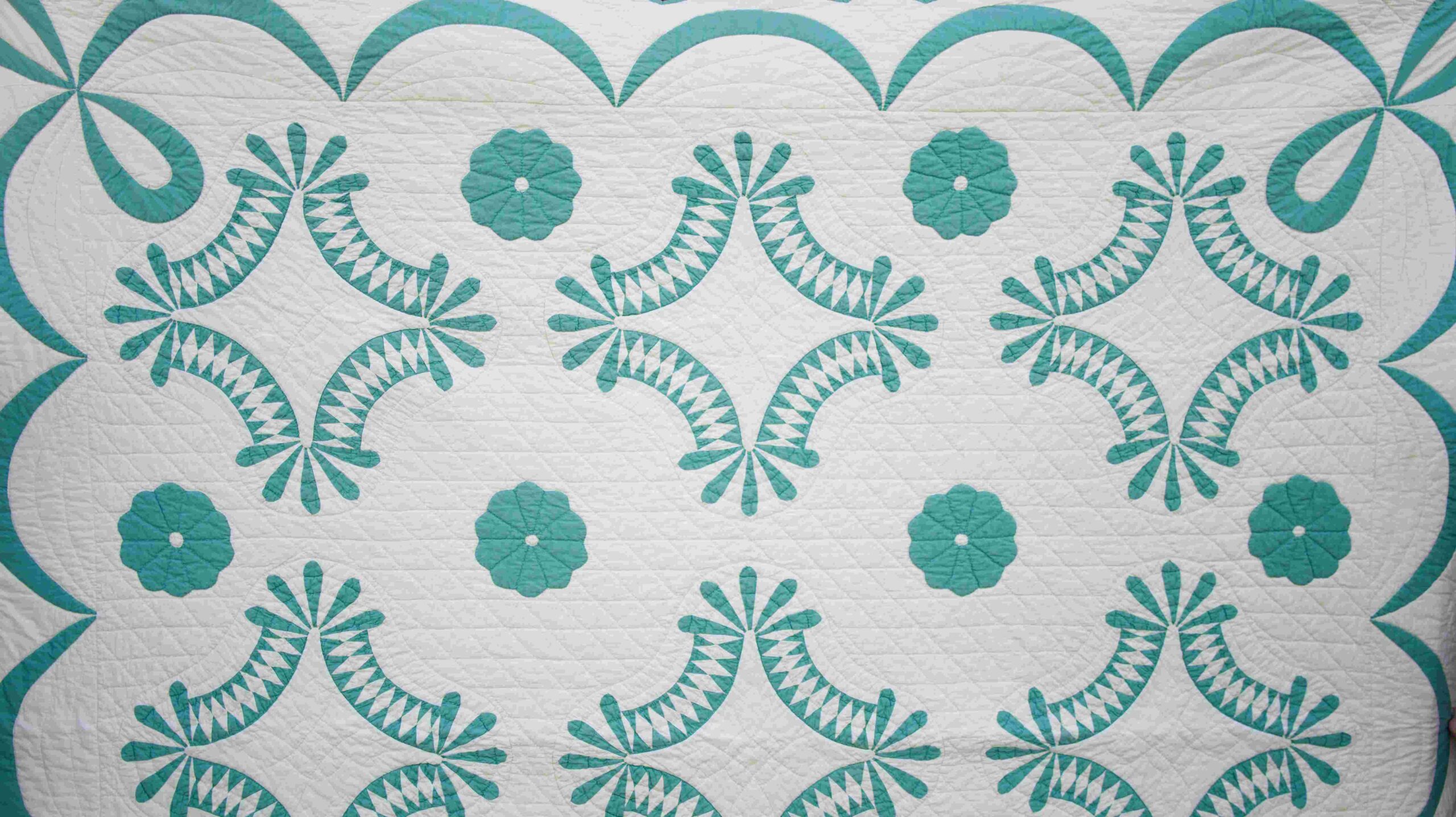 Handcrafted teal and white quilt pattern